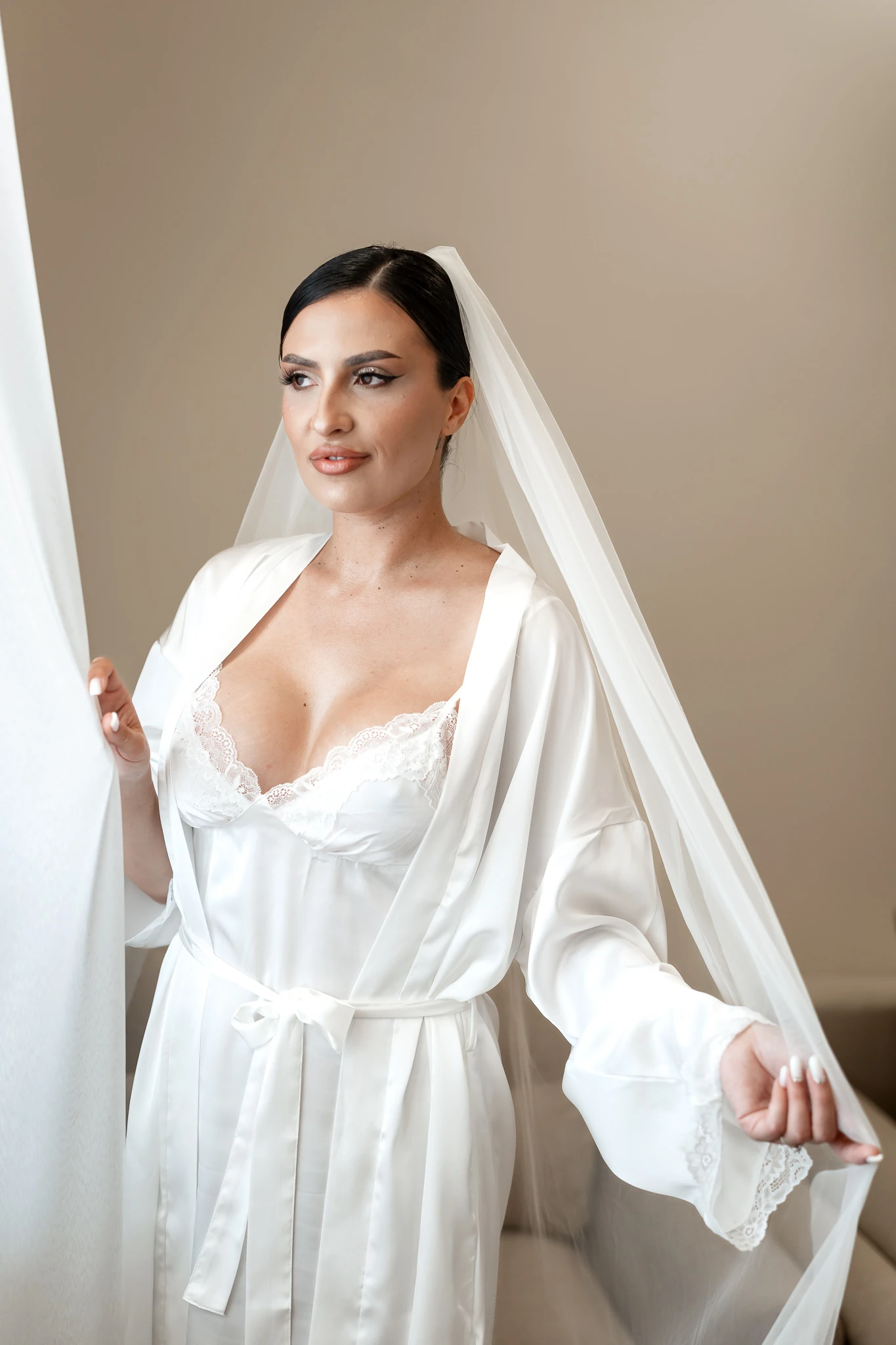 Mara în halat alb și voal lângă fereastră, portret de mireasă realizat în Țăndărei